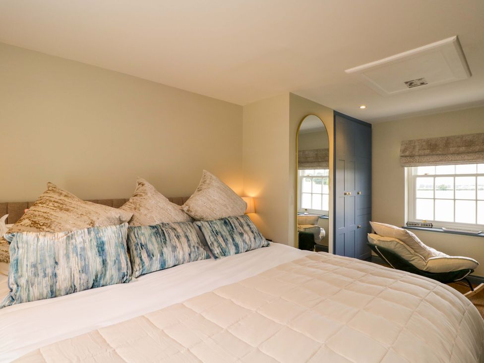 A bedroom with a bed and pillows at Beech in Newbury