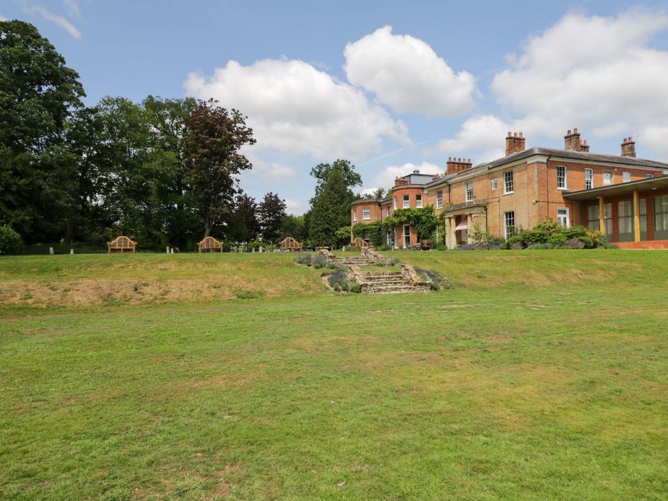 An outdoor area with benches and a house at Beech in Newbury