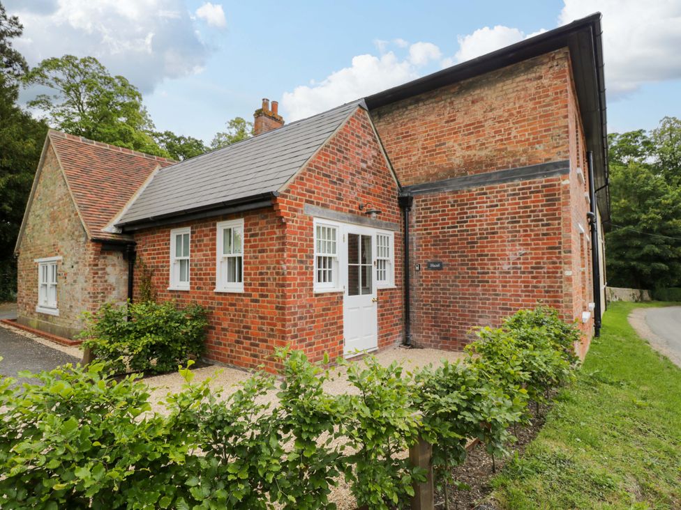 A brick house with a white door and windows at Hazel Elcot near Kintbury