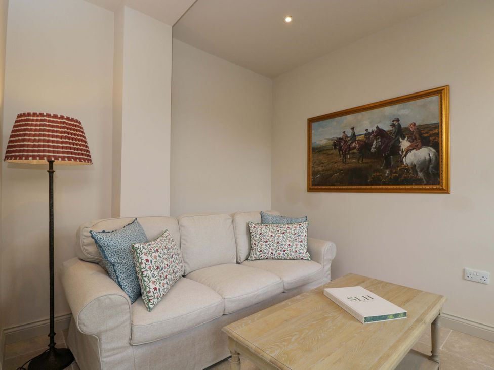 A snug with a sofa and a coffee table at Hazel in Elcot near Kintbury