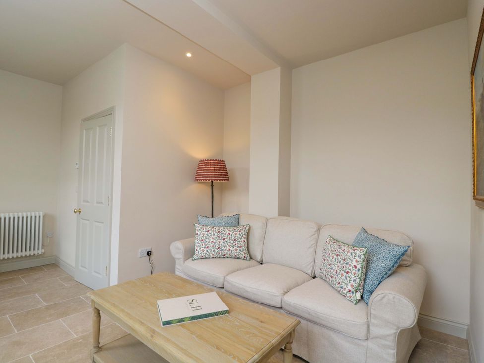 A living room with a sofa and a lamp at Hazel in Elcot near Kintbury