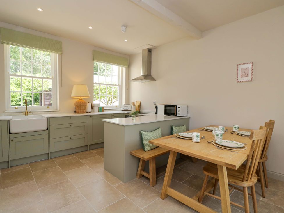 A kitchen with a dining table and chairs at Hazel in Elcot near Kintbury