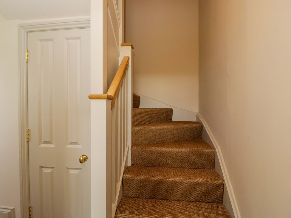 A staircase with a door at Hazel in Elcot near Kintbury