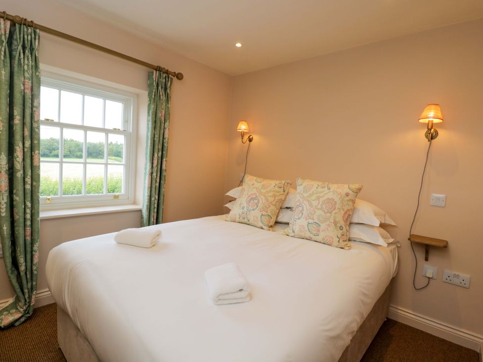 A bedroom with a bed and window at Hazel in Elcot near Kintbury