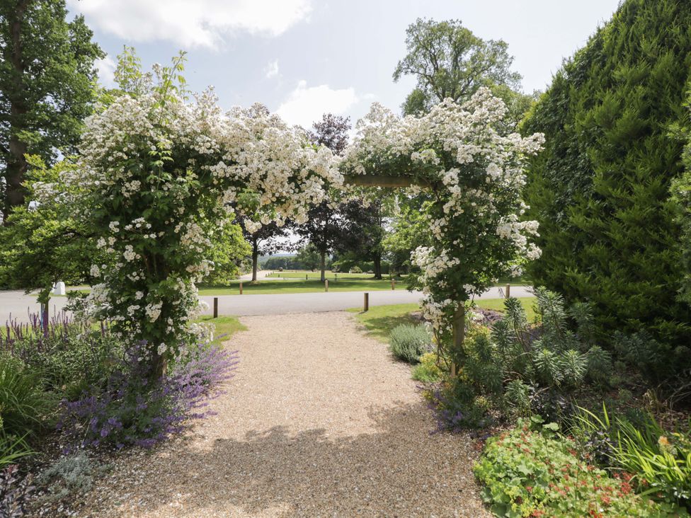 A garden with an archway covered in flowers at Hazel in Elcot near Kintbury