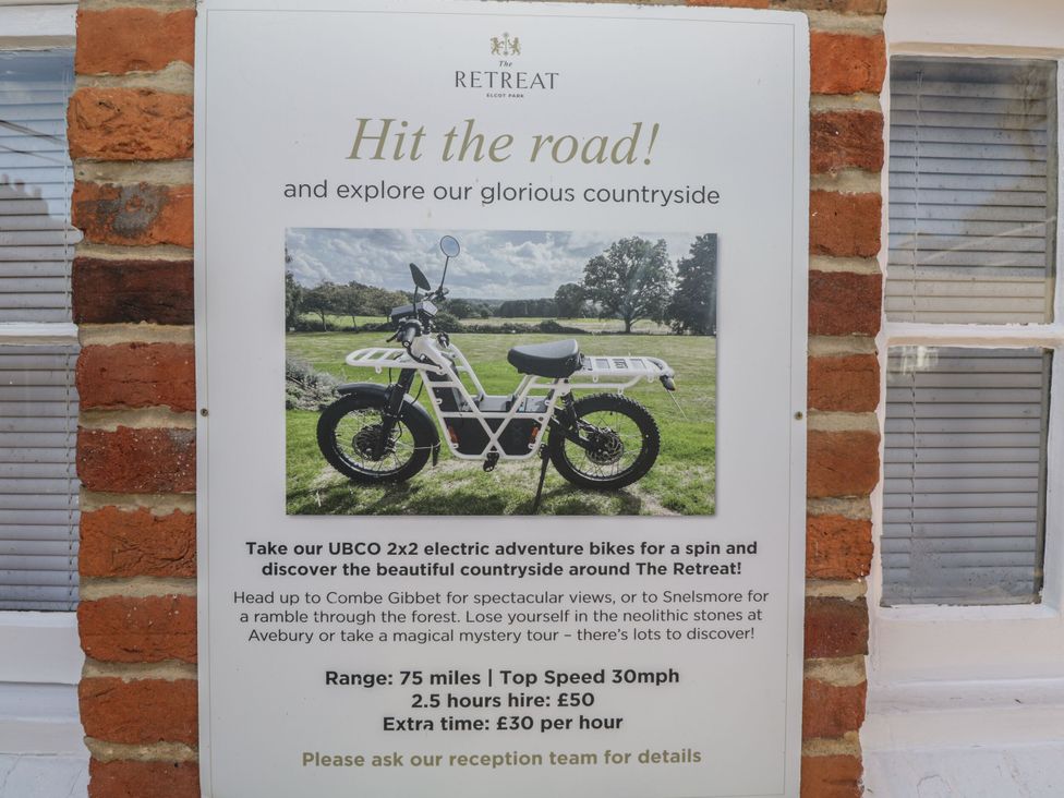 A sign promoting UBCO 2x2 electric adventure bikes for exploring countryside at The Retreat Elcot Park