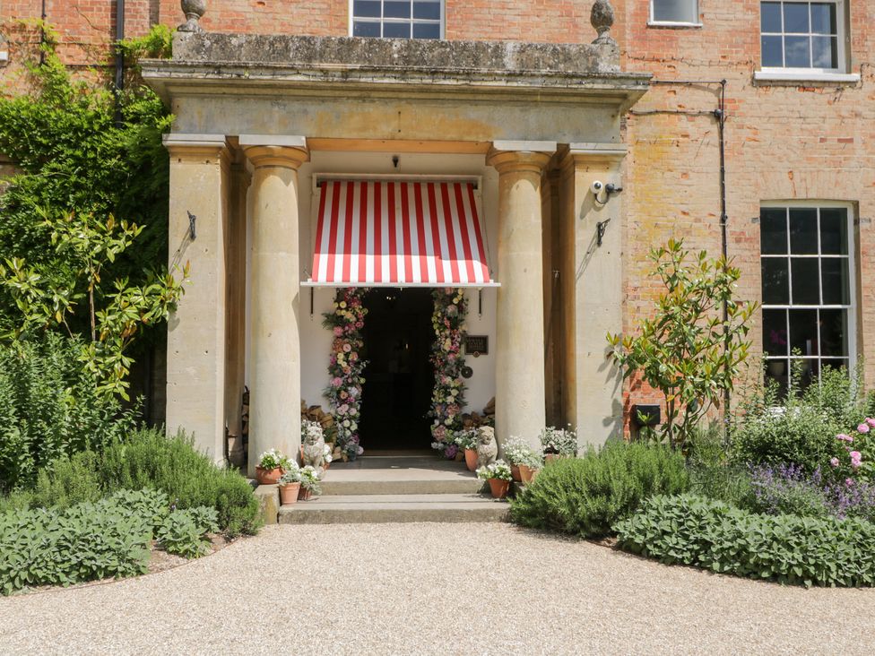 An entrance with flowers and a canopy at Oak Elcot near Newbury