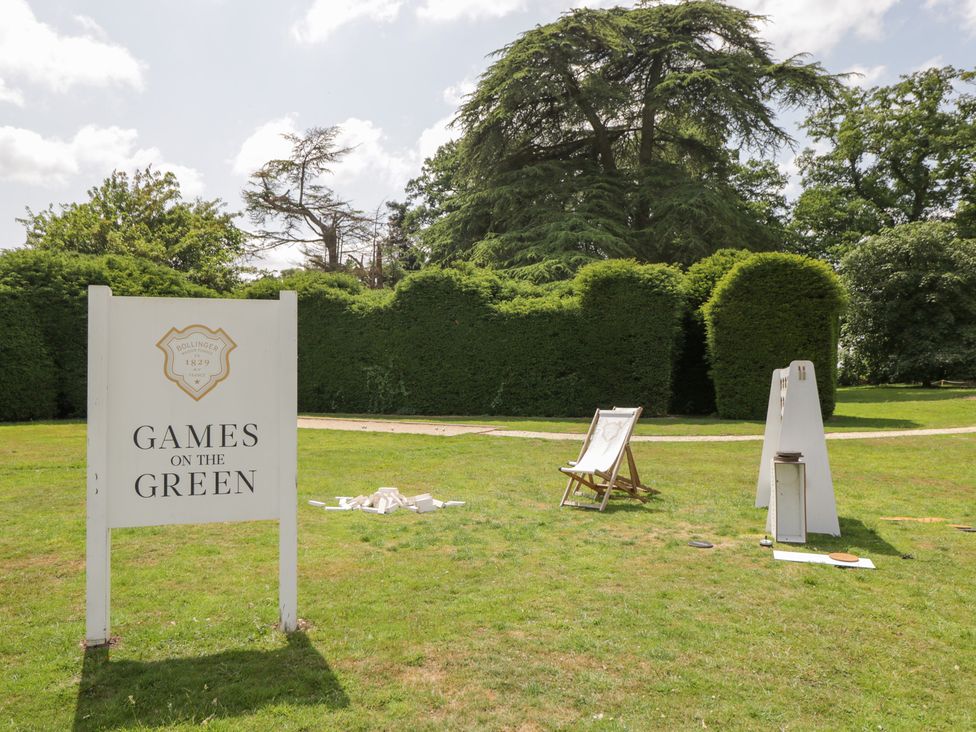 A garden area with a sign for games on the green at Oak in Elcot near Newbury