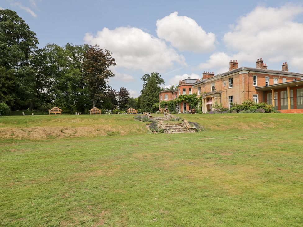 A house with benches and steps in the garden at Oak Elcot near Newbury