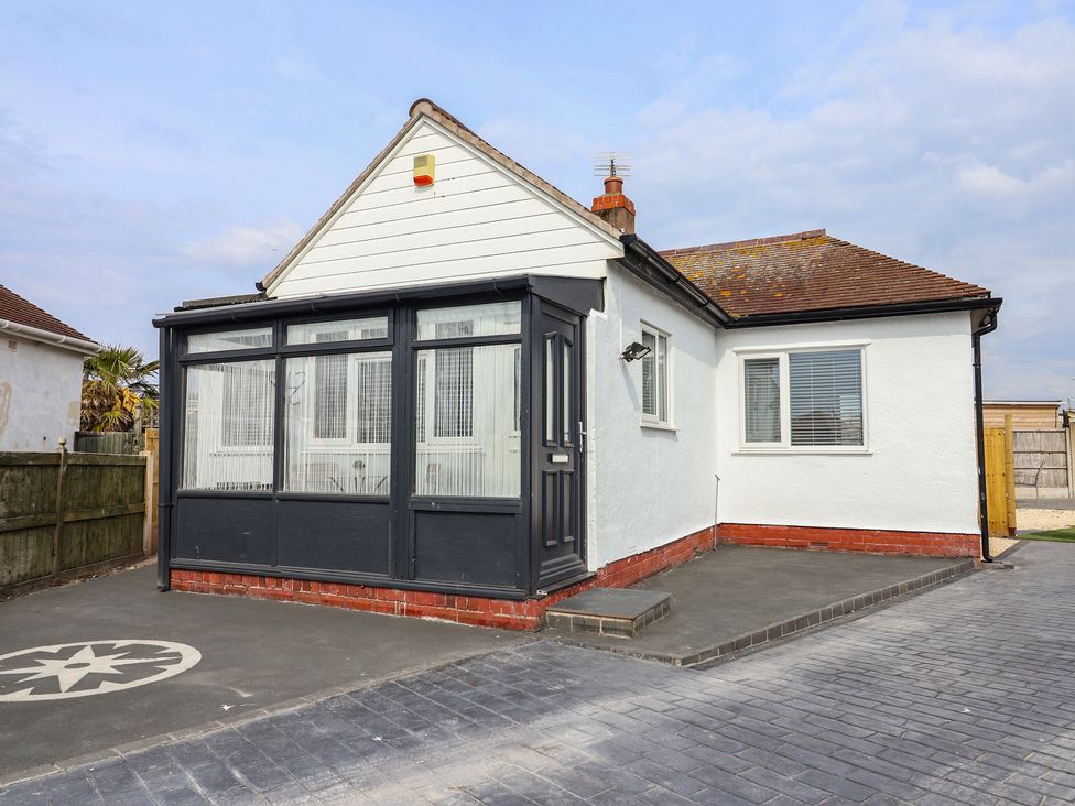 A house with a front porch and driveway at Driftwood in Rhyl