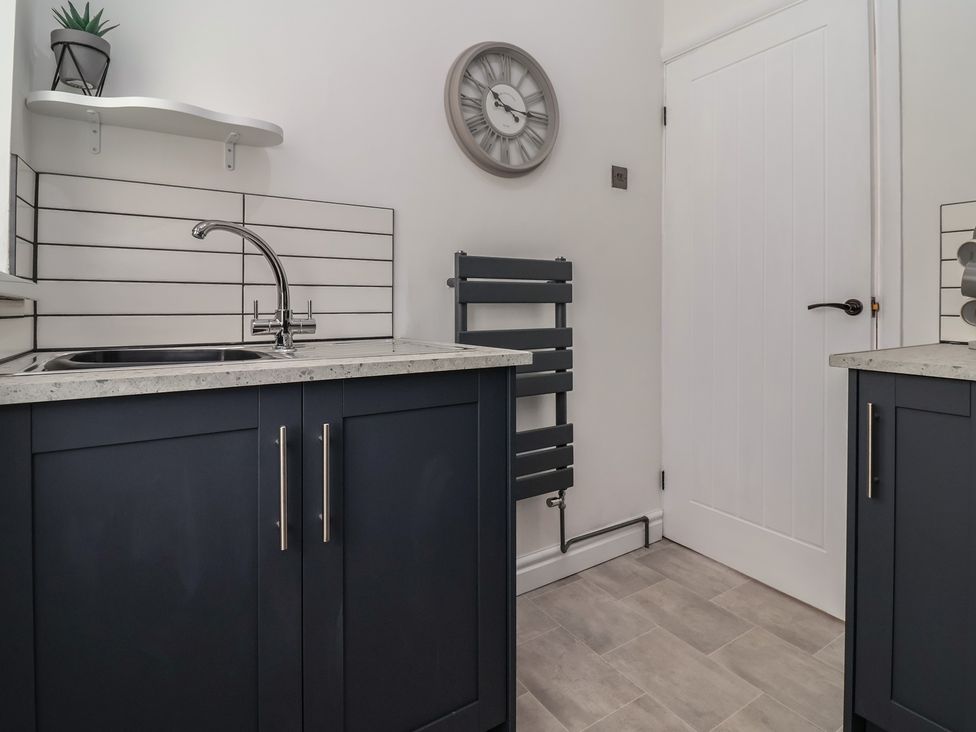 A kitchen with a sink and countertops at Driftwood in Rhyl
