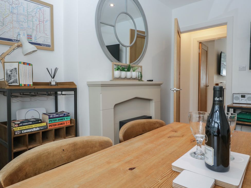 A dining room with a table and chairs at Highfield Cottage in Windermere