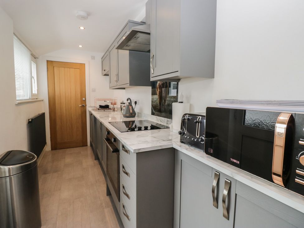 A kitchen with modern appliances at Highfield Cottage in Windermere