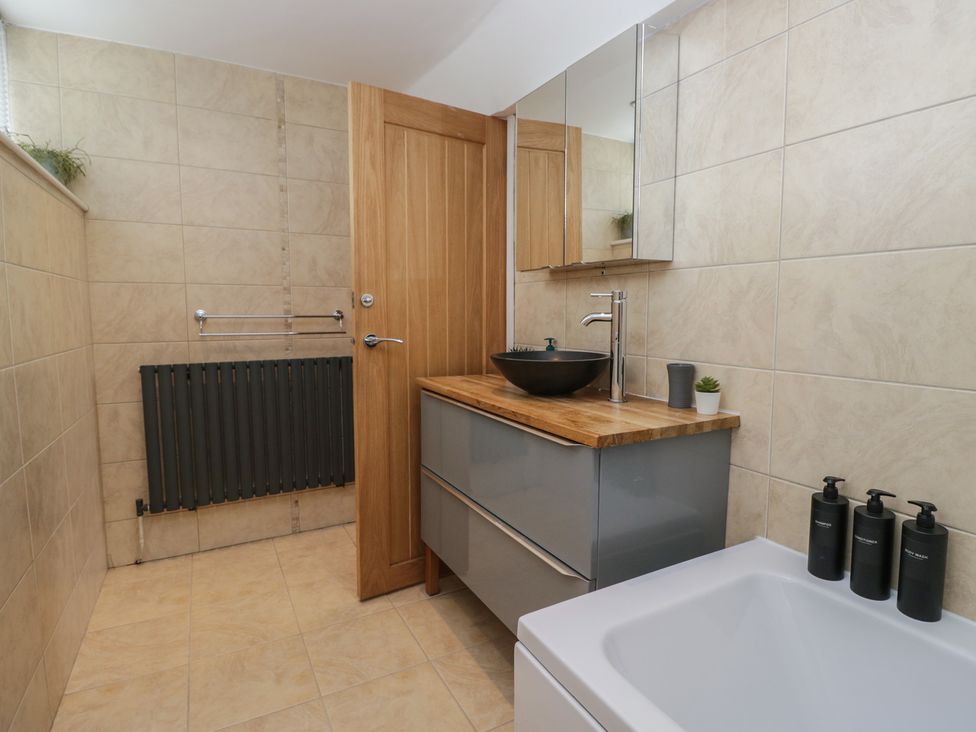 A bathroom with a sink and a bathtub at Highfield Cottage in Windermere
