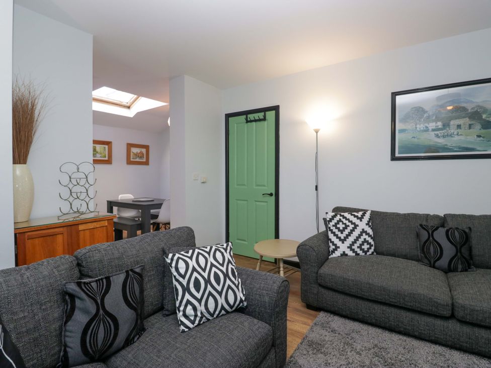 A living room with sofas and a table at Havelock Hideaway in Windermere