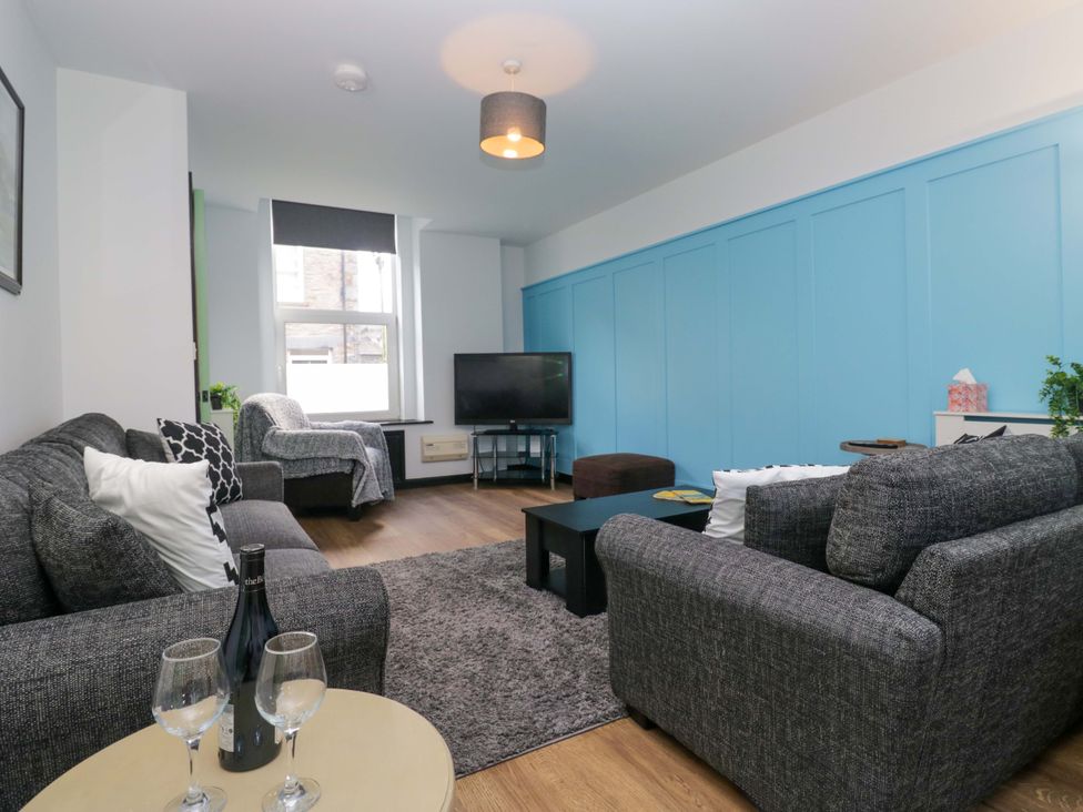 A living room with sofa and television at Havelock Hideaway in Windermere
