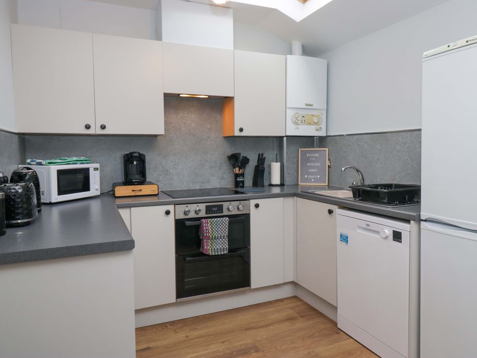 A kitchen with appliances and a sink at Havelock Hideaway in Windermere