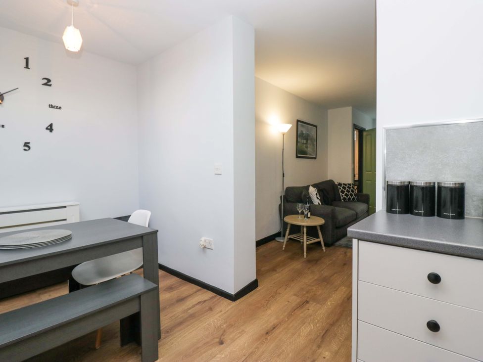 A dining room with a table and chairs at Havelock Hideaway in Windermere