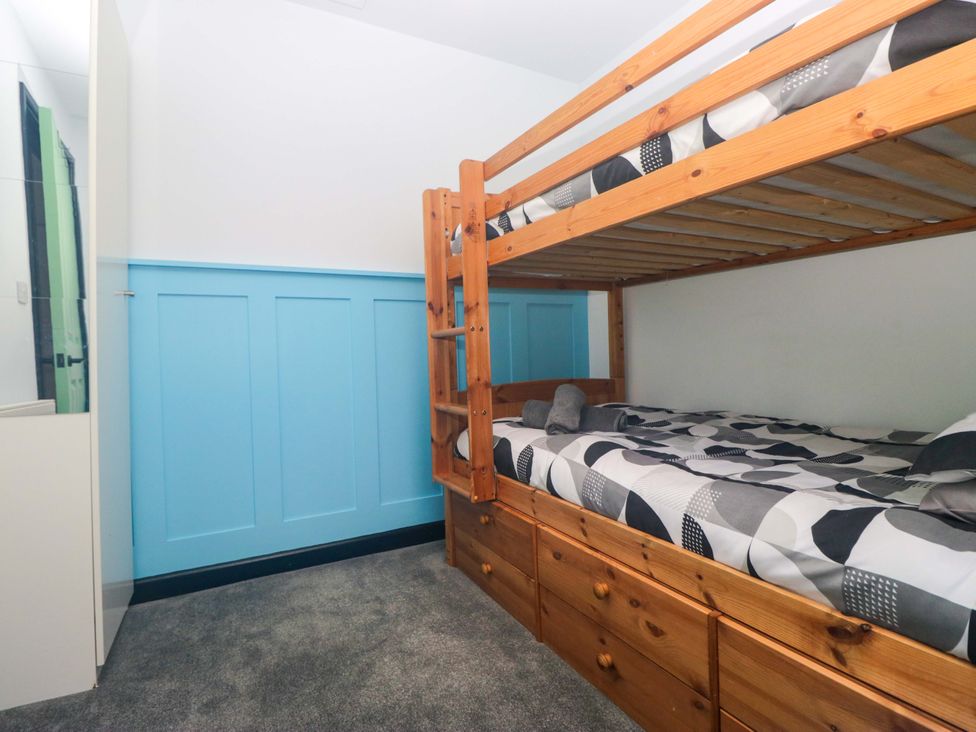 A bedroom with a bunk bed and storage drawers at Havelock Hideaway in Windermere