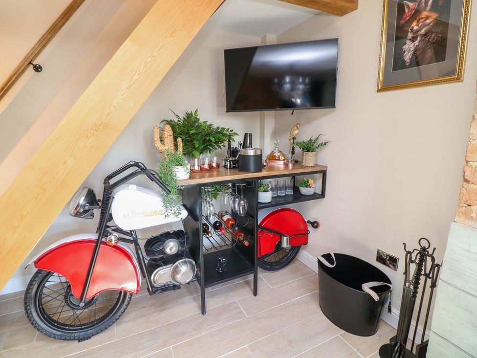 A snug with a motorcycle bar unit and a television at 7 The Row Grantham