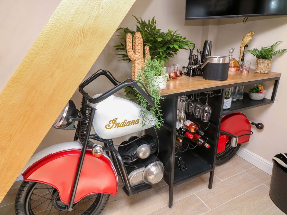 A bar area with a motorcycle and drinks setup at 7 The Row Grantham