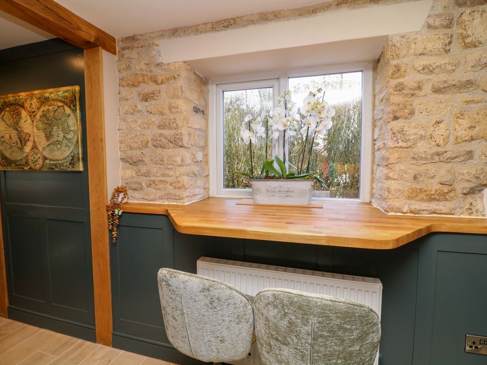 A kitchen with a window and potted plant at 7 The Row Grantham