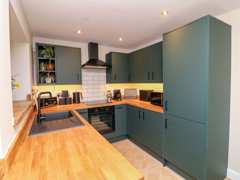 A kitchen with cabinets and appliances at 7 The Row Grantham