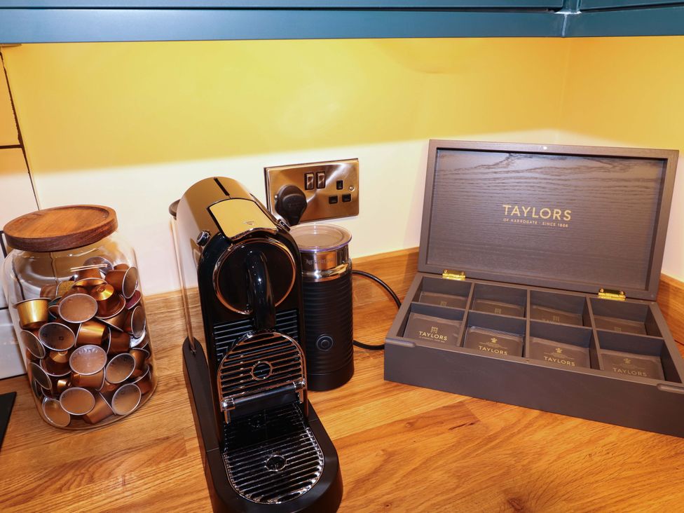 A kitchen with coffee machine and tea selection at 7 The Row Grantham