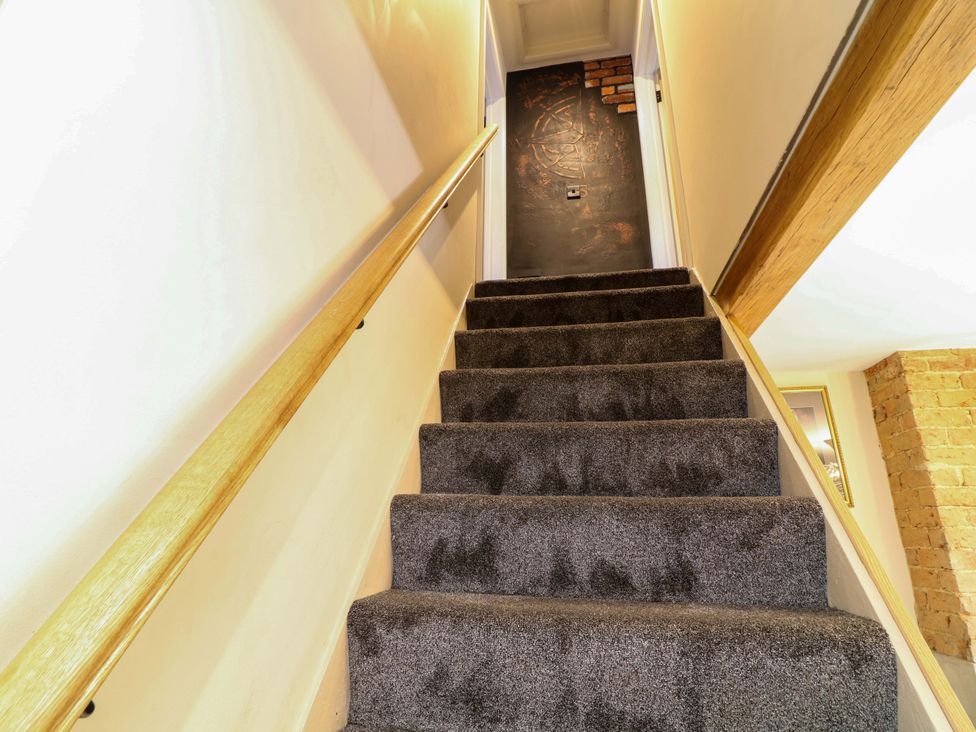 A staircase leading to a door at 7 The Row in Grantham