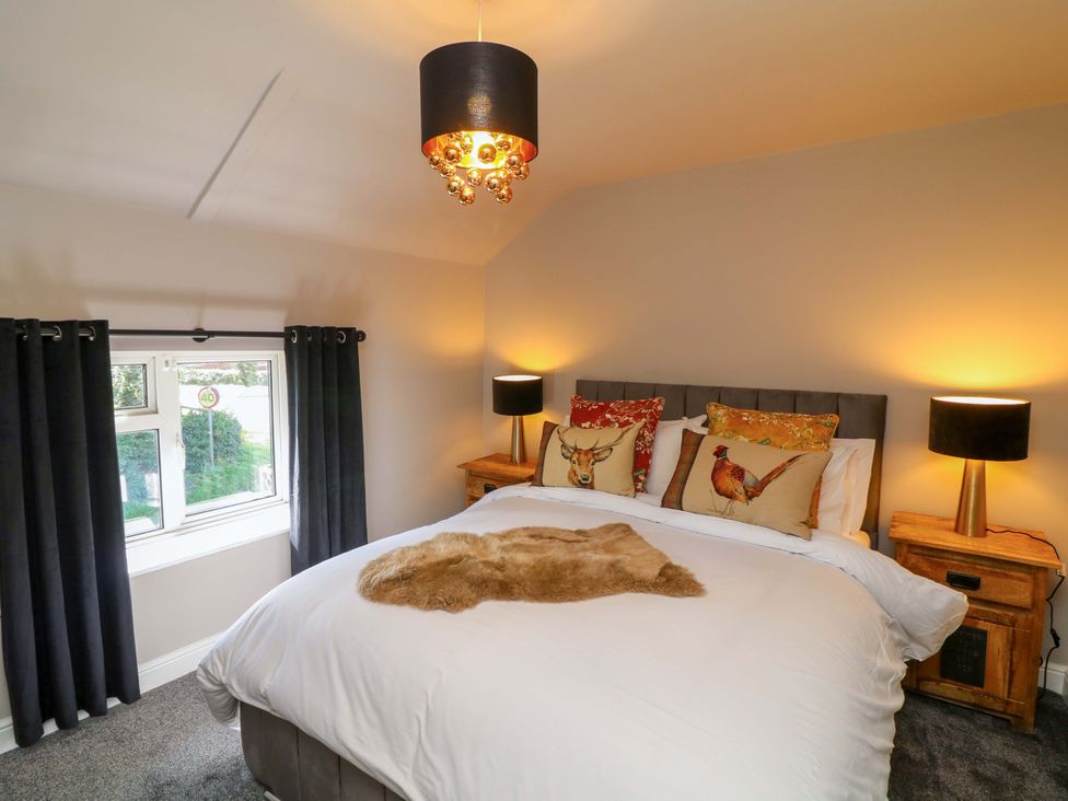 A bedroom with a bed and lamps at 7 The Row in Grantham
