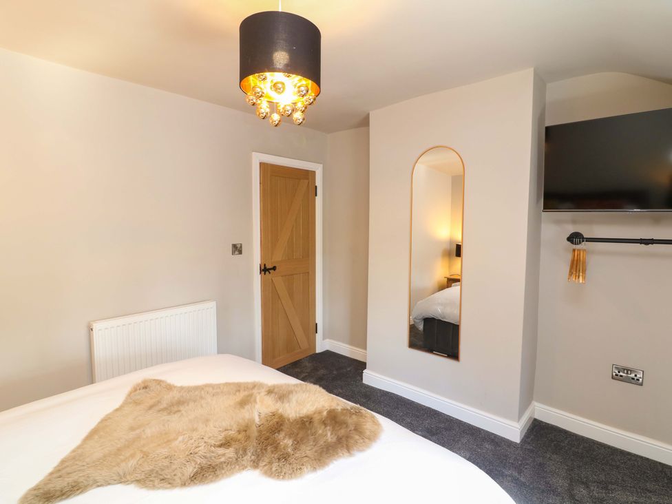 A bedroom with a bed and a television at 7 The Row Grantham