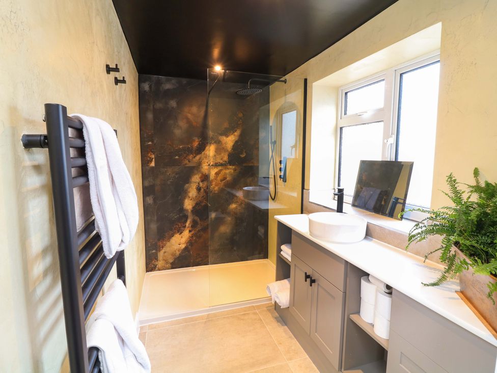 A bathroom with a shower and sink at 7 The Row Grantham