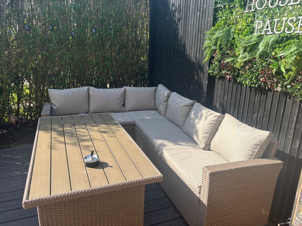 An outdoor seating area with a sofa and table at 7 The Row North Witham near Colsterworth