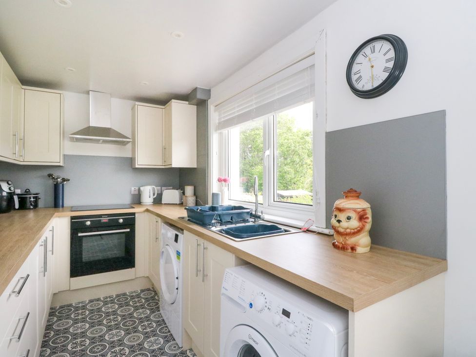 A kitchen with appliances and a working area at 3 Whin Bank Clachan-Seil near Balvicar Isle Of Seil