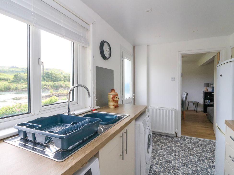 A kitchen with a sink and dish rack at 3 Whin Bank Clachan-Seil near Balvicar Isle Of Seil