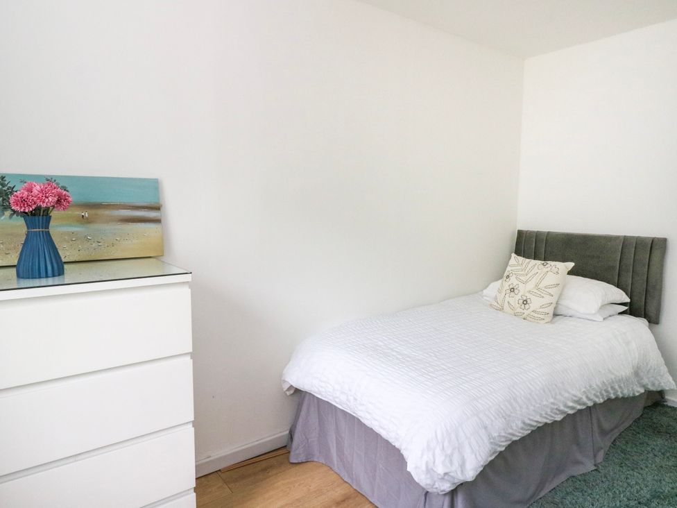 A bedroom with a bed and dresser at 3 Whin Bank Clachan-Seil near Balvicar Isle Of Seil