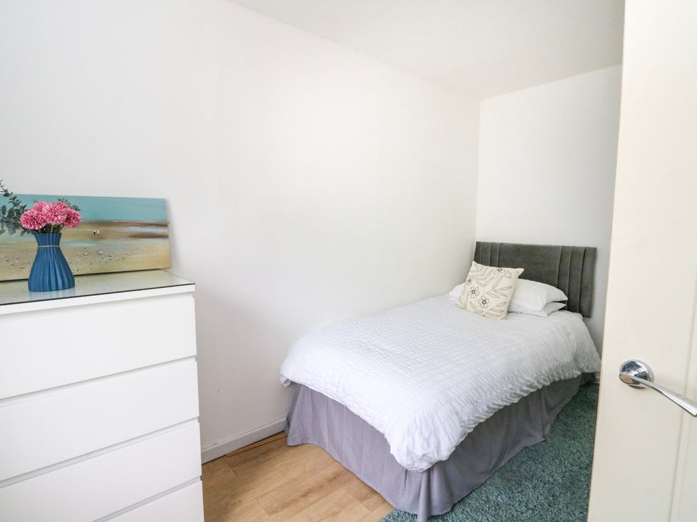A bedroom with a bed and dresser at 3 Whin Bank in Clachan-Seil near Balvicar, Isle Of Seil