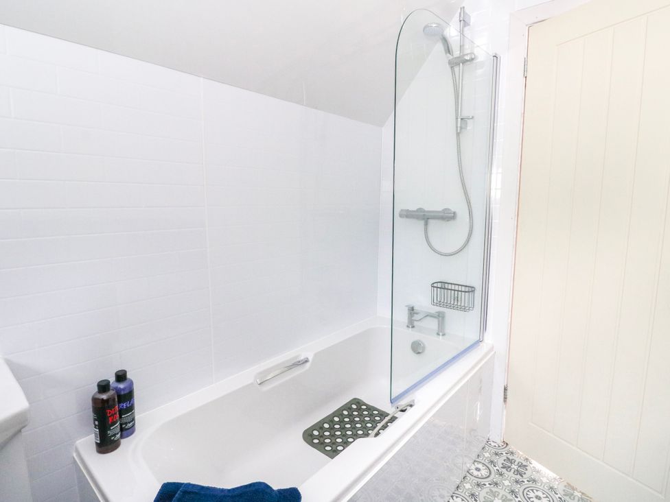 A bathroom with a bathtub and shower at 3 Whin Bank Clachan-Seil near Balvicar Isle Of Seil