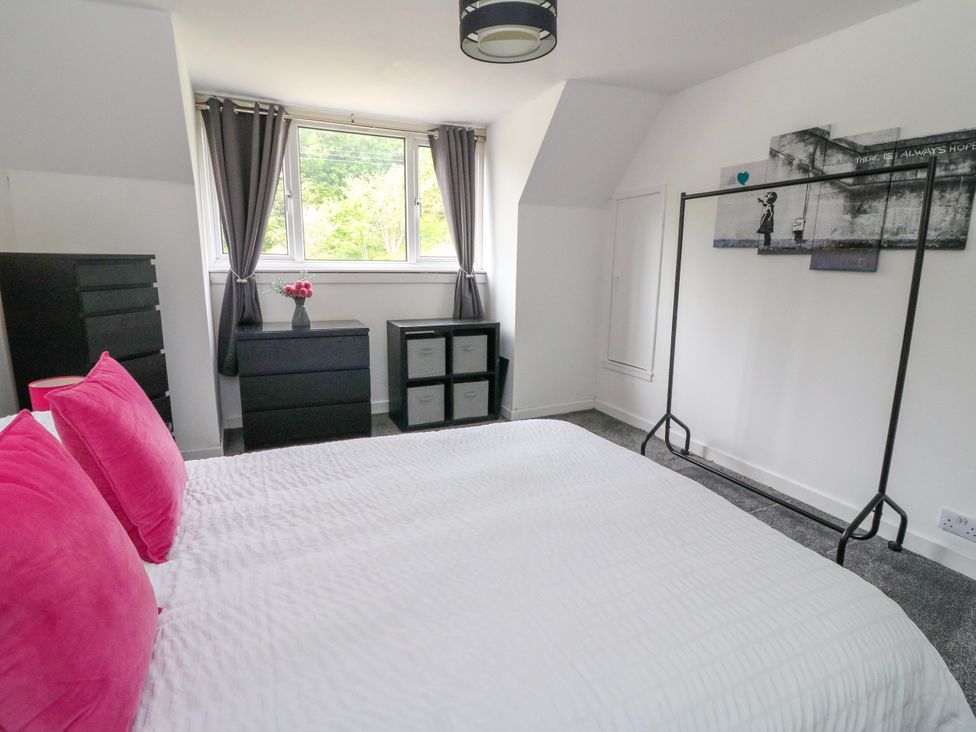 A bedroom with a bed and storage units at 3 Whin Bank Clachan-Seil near Balvicar Isle Of Seil
