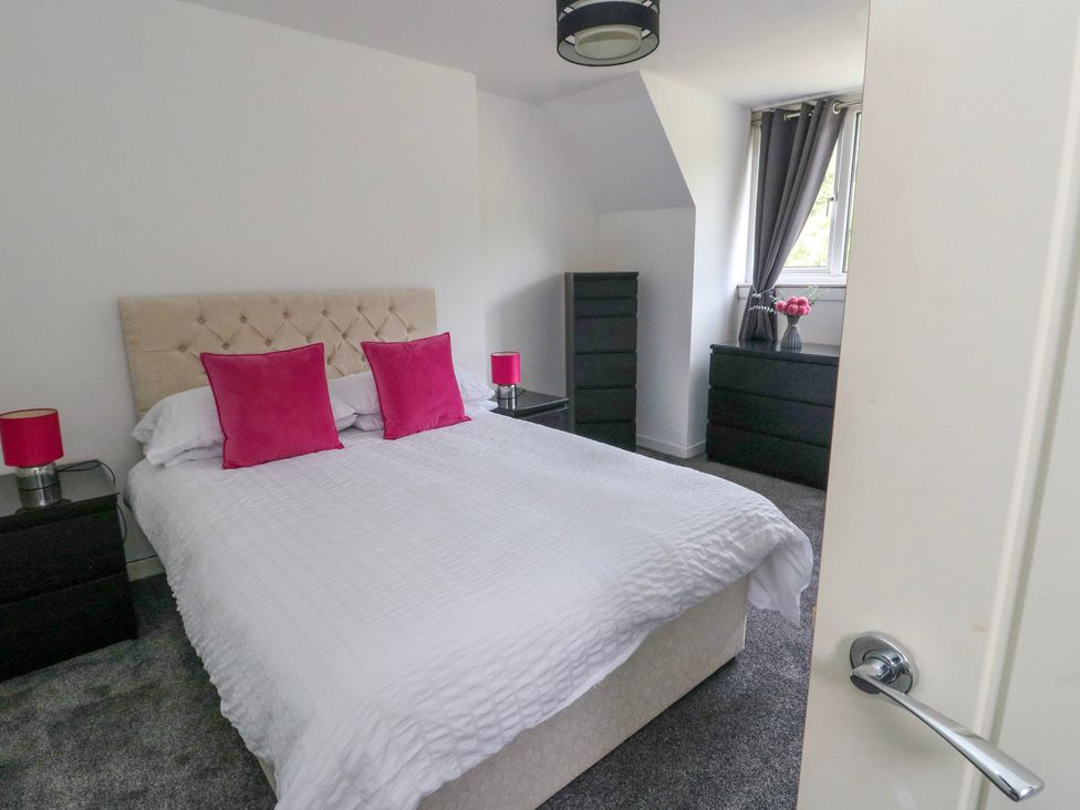 A bedroom with a bed and nightstands at 3 Whin Bank Clachan-Seil near Balvicar Isle Of Seil
