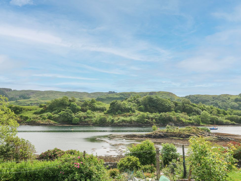 A view of a river with hills and trees at 3 Whin Bank Clachan-Seil near Balvicar Isle Of Seil