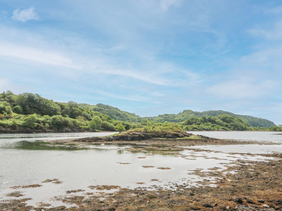 A scenic view of a river with hills and sky at 3 Whin Bank Clachan-Seil near Balvicar Isle Of Seil
