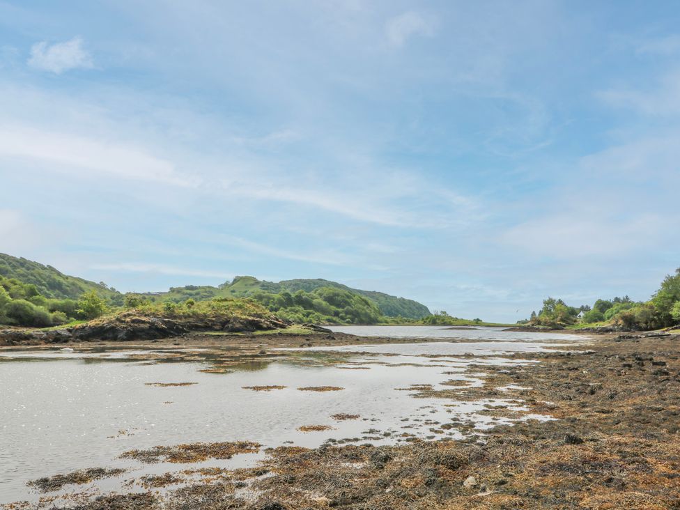 A coastal landscape with water and hills at 3 Whin Bank Clachan-Seil near Balvicar Isle Of Seil