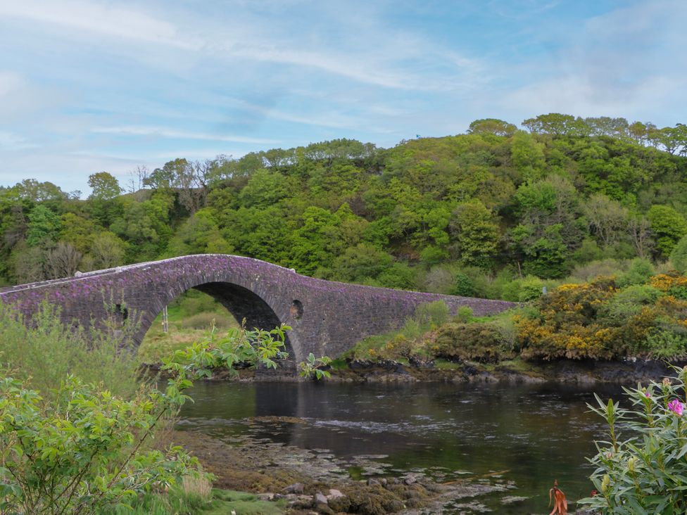 A bridge over water with greenery around at 3 Whin Bank in Clachan-Seil near Balvicar, Isle Of Seil