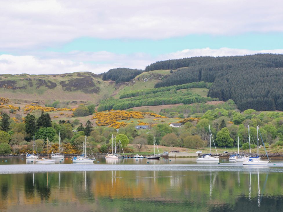 A view of boats on water with hills and trees at 3 Whin Bank Clachan-Seil near Balvicar, Isle Of Seil
