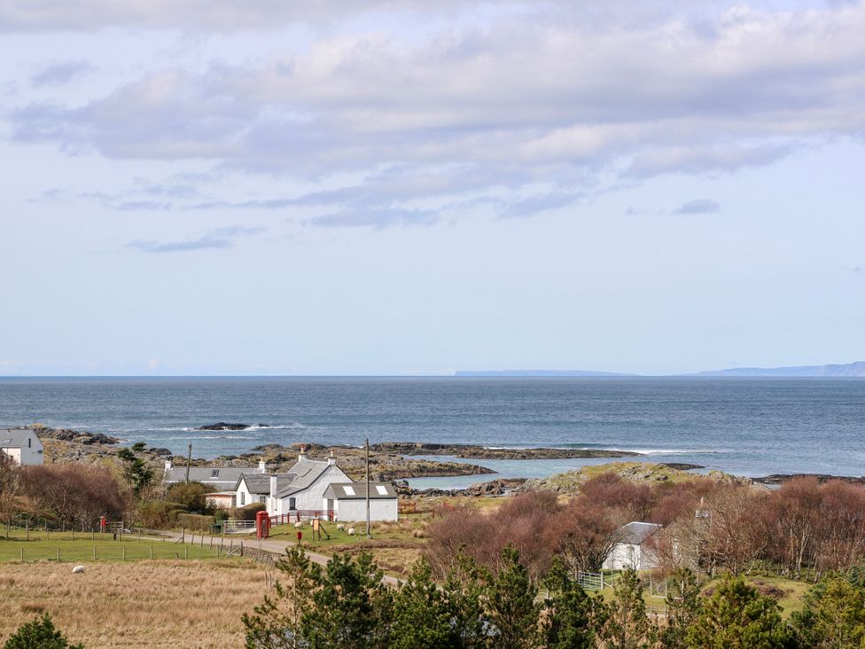 A coastal view with houses and the ocean at 3 Whin Bank Clachan-Seil near Balvicar Isle Of Seil