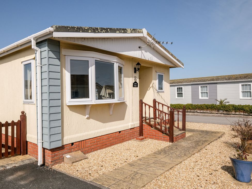 A house exterior with a pathway and steps at Lazy Days in St Merryn
