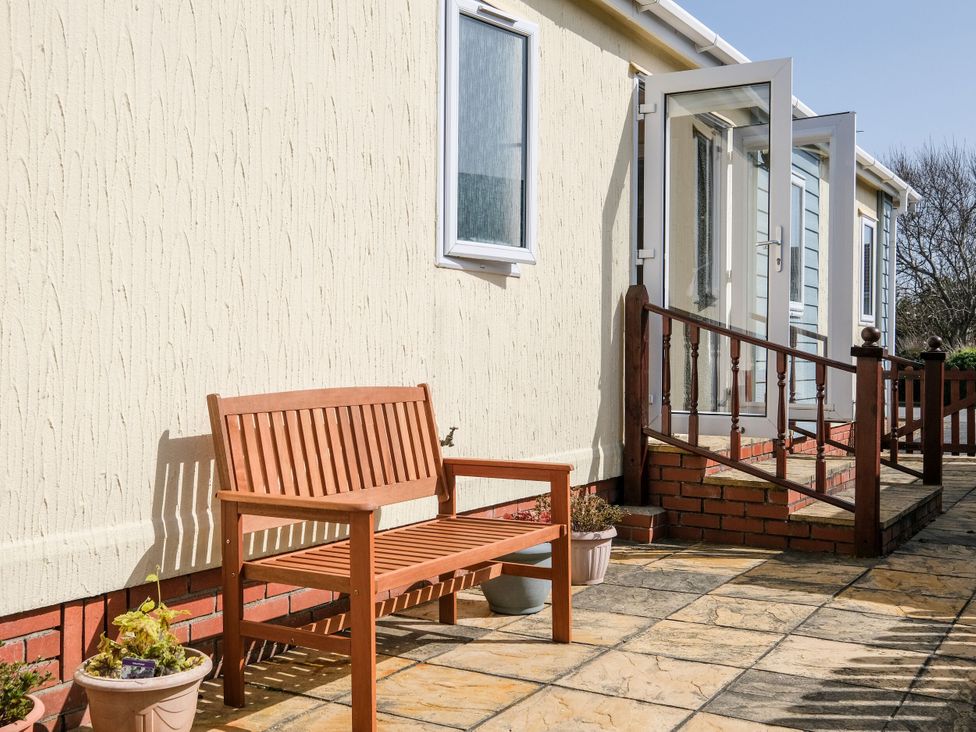 An outdoor area with a bench and steps at Lazy Days in St Merryn