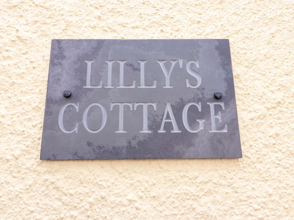 A nameplate displaying the text LILLY'S COTTAGE
