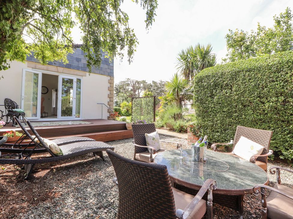 A garden with a table and chairs at Mount House Bryniau near Dyserth